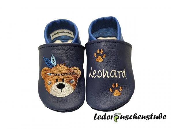 Lederpuschen dunkellblau-jeansblau; rechts IndiBär braun-creme Federn jeanblau-babyblau; links Namen creme und 2 Tatzen braun von vorne